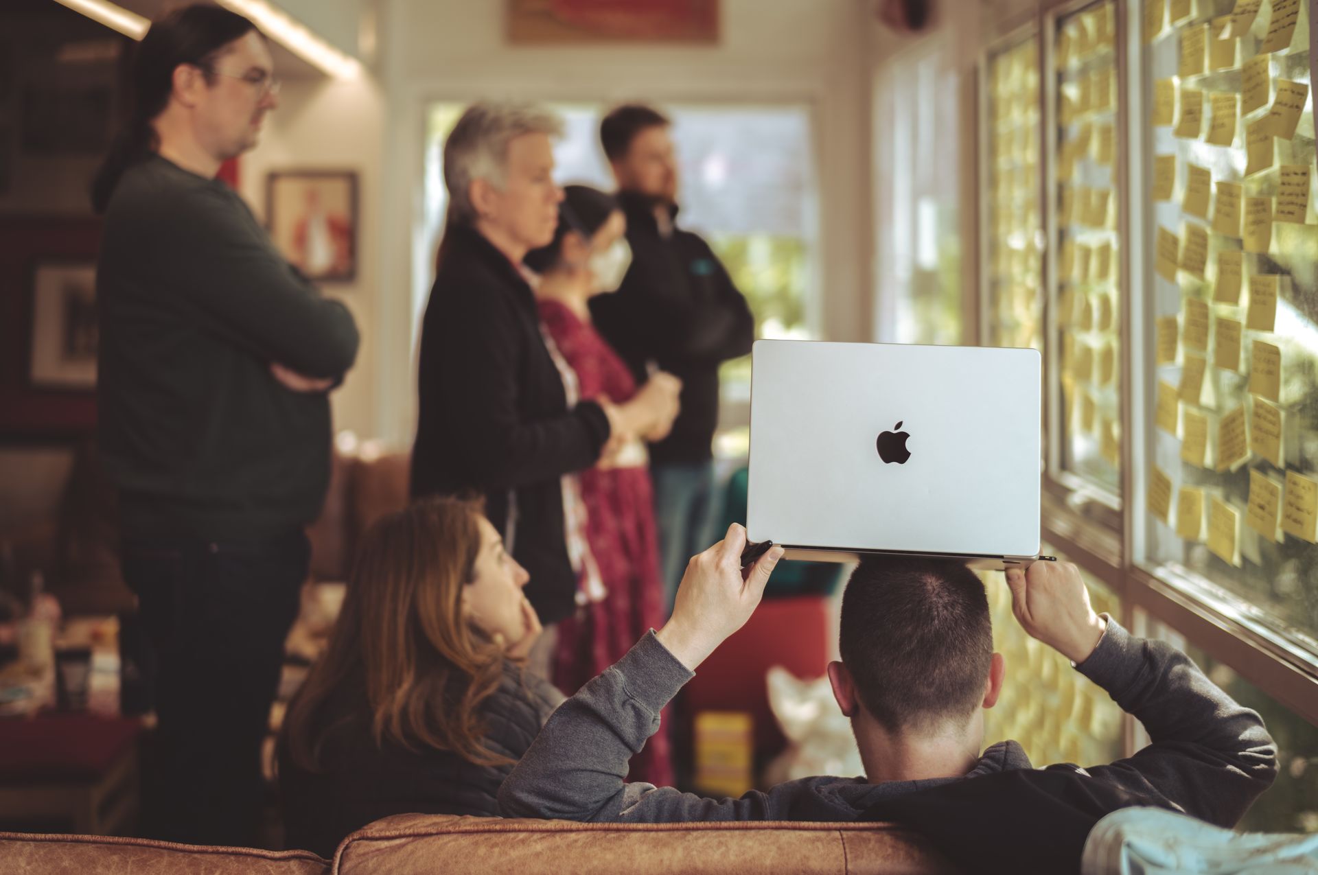 Gábor holding a laptop on his head, making sure remote attendees could see and participate in the activities.